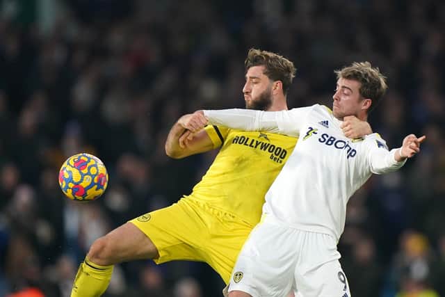 Brentford's Charlie Goode (left) and Leeds United's Patrick Bamford battle for the ball (Picture: PA)