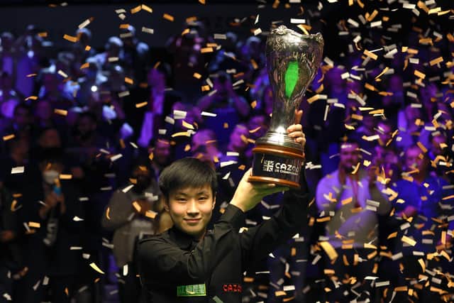 Zhao Xintong lifts the trophy after winning the final of the Cazoo UK Championship at the York Barbican. Pictures: PA