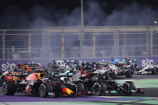 Neck and neck: Red Bull driver Max Verstappen of the Netherlands, left, and Mercedes driver Lewis Hamilton of Britain in action during the Formula One corniche circuit, in Jiddah.. (AP Photo/Amr Nabil)