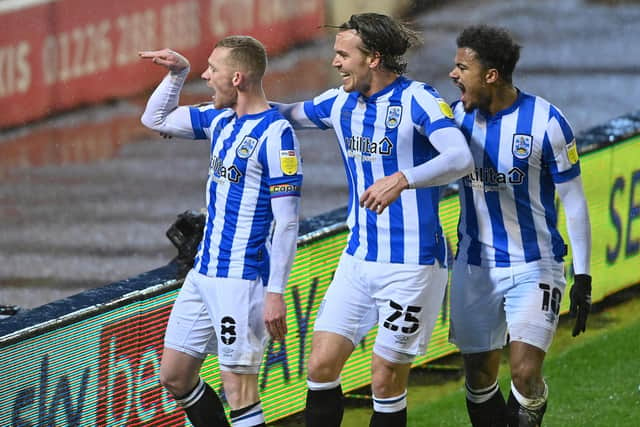 Leading the way: Captain Lewis O'Brien celebrates scoring  Huddersfield's goal.