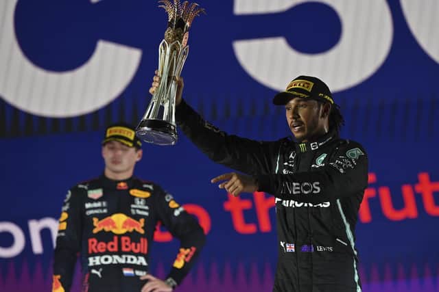 Mercedes driver Lewis Hamilton of Britain celebrates winning the Formula One Saudi Arabian Grand Prix in front of the second placed Red Bull driver Max Verstappen of the Netherlands (Andrej Isakovic, Pool Photo via AP)