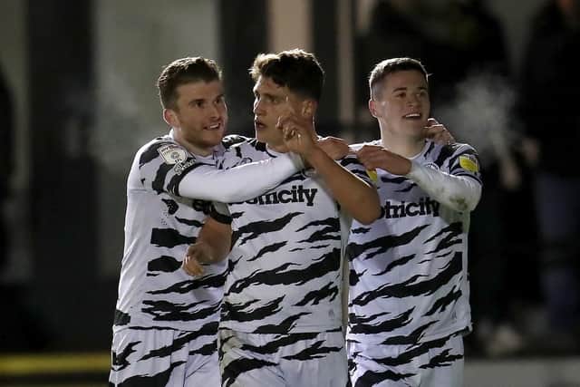 Forest Green's Mathew Stevens (centre) celebrates with team-mates after scoring at Harrogate.