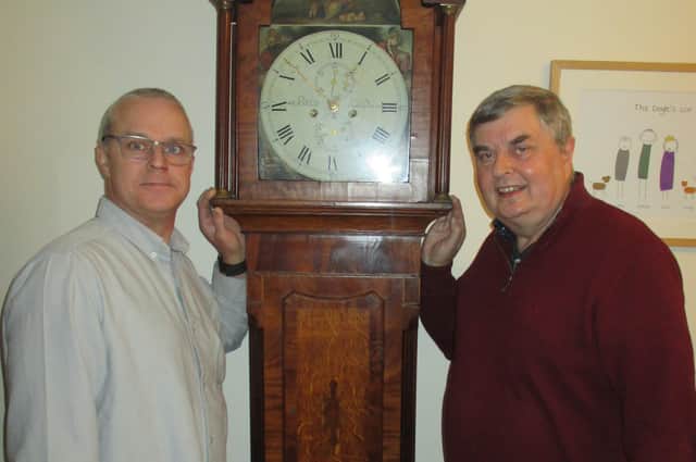 John Doyle (left) gives Pocklington District Heritage Trust trustee Andrew Sefton some advice on the workings of the grandfather clock. Photo courtesy of Pocklington District Heritage Trust