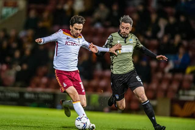 Bradford City's Alex Gilliead holds off Colchester rival Cole Skuse. Picture: Tony Johnson.
