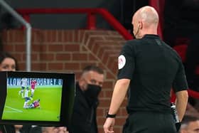 Referee Anthony Taylor consults VAR after a tackle during the Premier League match at Old Trafford. Picture: PA
