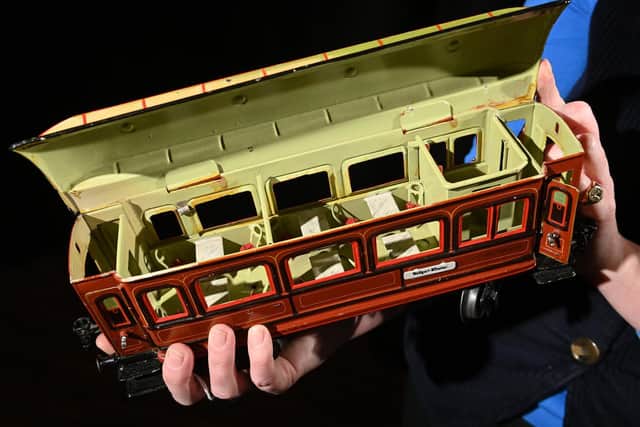Harriet Hunter-Clarke with Lot no: 3331 Marklin Gauge 1 Dining Coach (£500-700), part of the upcoming Toys & Models, Sporting & Fishing auction at Tennants on the 15th December.  Picture Bruce Rollinson