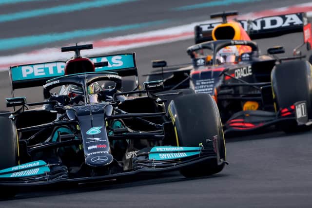 Rivals: Mercedes' British driver Lewis Hamilton (L) drives ahead of Red Bull's Dutch driver Max Verstappen (R) at the Yas Marina Circuit during the second free practice session of the Abu Dhabi Formula One Grand Prix on December 10, 2021. (Picture: GIUSEPPE CACACE/AFP via Getty Images)