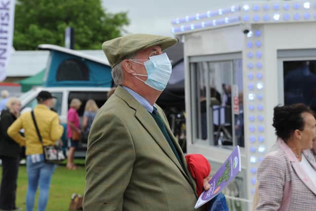 A man wears a face covering at the Great Yorkshire Show earlie this year. Masks are once again required in most indoor venues in England.