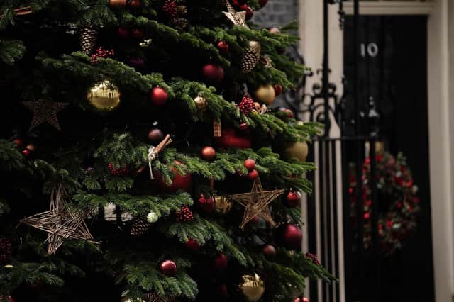Ornaments and baubles hang from the Christmas tree outside 10 Downing Street, Westminster, London.