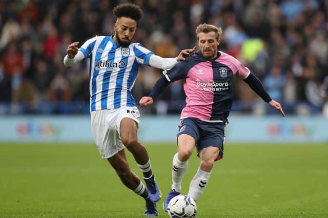 Huddersfield Town's Sorba Thomas (left) and Coventry City's Jamie Allen battle for the ball.