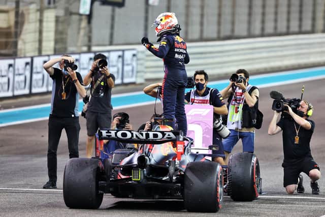Winning drive: Red Bull's Max Verstappen celebrates winning his first Formula One world championship at the season-ending Abu Dhabi Grand Prix. AP