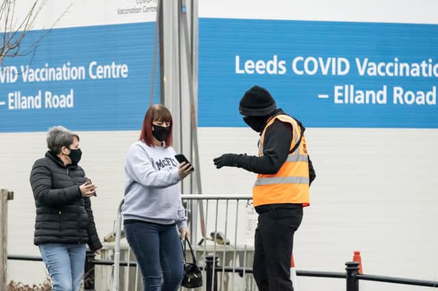 People arrive at a Covid-19 vaccination centre at Elland Road in Leeds, Yorkshire.