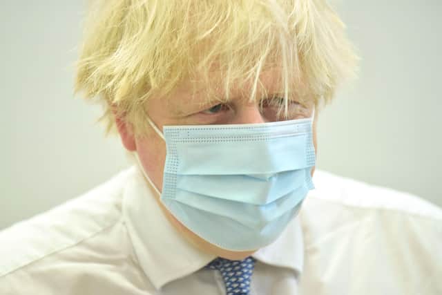 Boris Johnson during a visit to a Covid vaccine centre where he dodged questions about multiple Downing Street scandals.