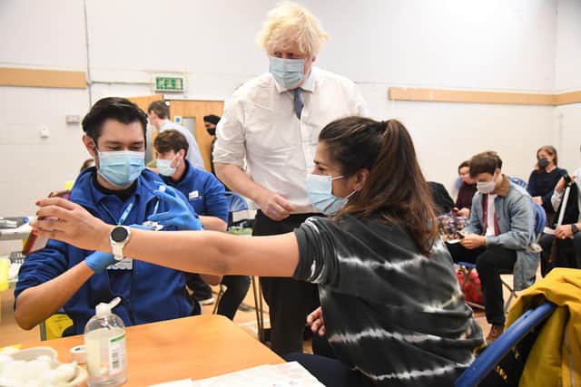 Boris Johnson during a visit to a Covid vaccine centre where he dodged questions about multiple Downing Street scandals.