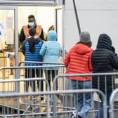 People arrive at a Covid-19 vaccination centre at Elland Road in Leeds.
