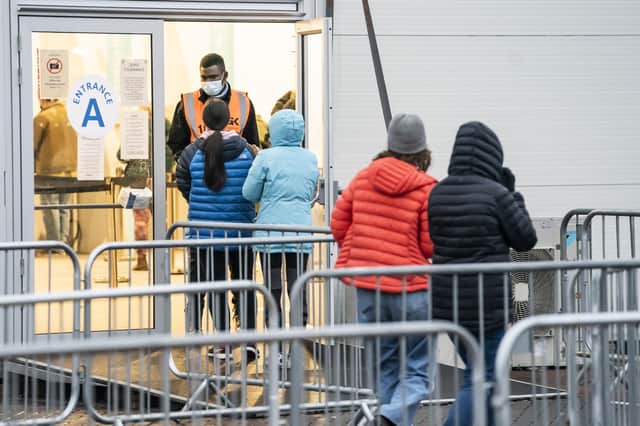 People arrive at a Covid-19 vaccination centre at Elland Road in Leeds.