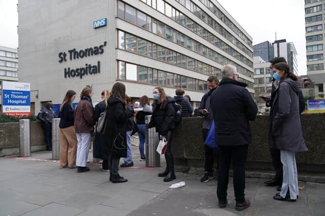 People queuing for booster jabs at St Thomas' Hospital, London.