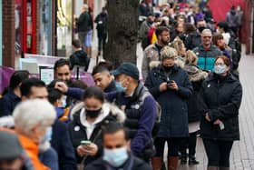Hundreds of people queue at a vaccination centre on Solihull High Street, West Midlands