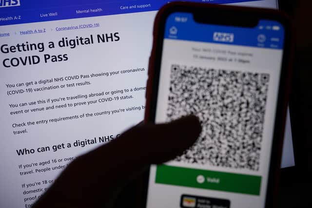 A person's NHS COVID domestic Pass is displayed on a smartphone screen within the NHS App, as new restrictions will come into force to slow the spread of the Omicron variant of coronavirus