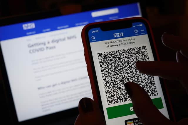 A person's NHS COVID domestic Pass is displayed on a smartphone screen within the NHS App, as new restrictions will come into force to slow the spread of the Omicron variant of coronavirus.