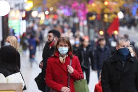 Members of the public wearing face masks as they walk along Oxford Street in London