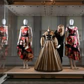 Belonging: Fashion & A Sense of Place at the Bankfield Museum, Halifax. Elinor Camille-Wood, Curator, with the Alexander McQueen dresses inspired by Wuthering Heights, alongside an archive Yorkshire dress dating from the Brontes' era. Picture Bruce Rollinson