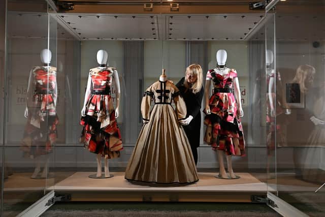 Belonging: Fashion & A Sense of Place at the Bankfield Museum, Halifax. Elinor Camille-Wood, Curator, with the Alexander McQueen dresses inspired by Wuthering Heights, alongside an archive Yorkshire dress dating from the Brontes' era. Picture Bruce Rollinson
