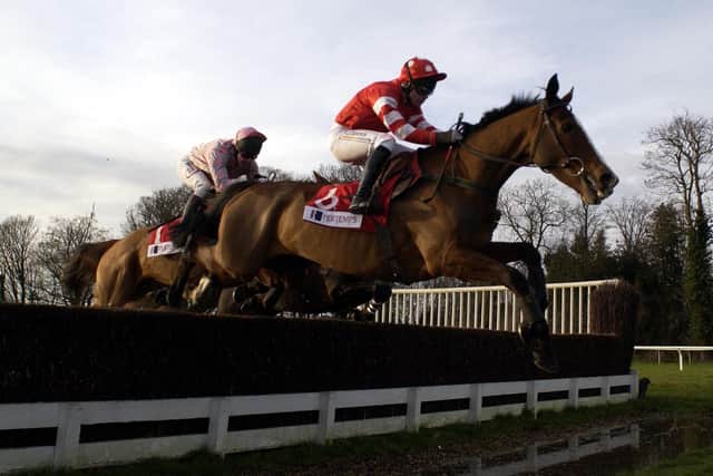 Adrian Maguire and Florida Pearl clear the water jump before landing the 2001 King George VI Chase run at Kempton Park.  Credit: Julian Herbert/Getty Images.