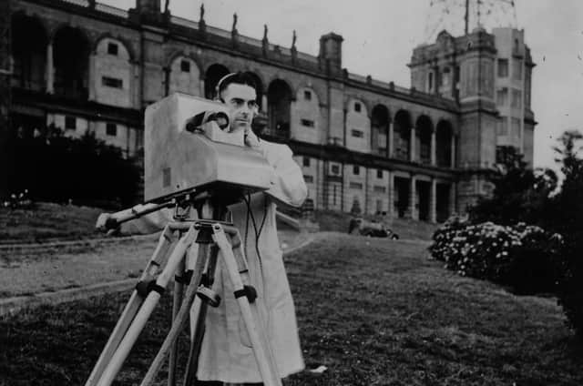 23rd August 1936:  D G  Birkinshaw operating the Marconi-EMI instantaneous TV camera transmitting the view from Alexandra Palace, the BBC's first high definition TV station. In the background are the mast and transmitting aerials of the Palace.  (Photo by Topical Press Agency/Getty Images)
