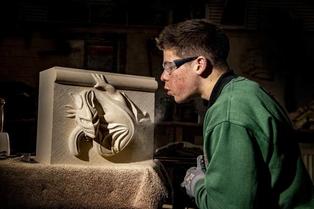 Charlie Gee apprentice stone mason at York Minster carving a dragon