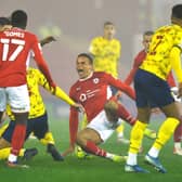 ouch: Barnsley’s Carlton Morris is brought down by West Brom’s Jake Livermore, during their Championship game at Oakwell. Picture: Bruce Rollinson