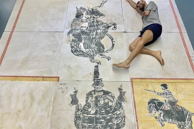 Mohammad Barrangi, pictured lying next to one of his prints, is to have his artwork exhibited at the Edinburgh Printmakers from January next year (Photo: Mohammad Barrangi)