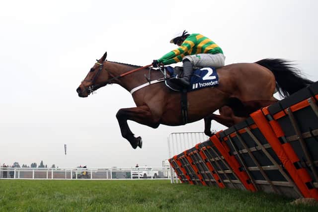 Champ and Jonjo O'Neill junior en route to winning Ascot's Long Walk Hurdle.