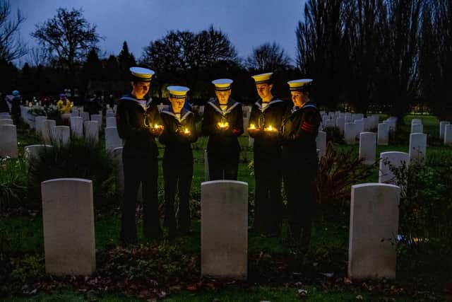 Sea Cadets place candles at Canadian Air Force graves during a Candlelit Christmas Remembrance at the Commonwealth War Graves at Stonefall Cemetery, Harrogate