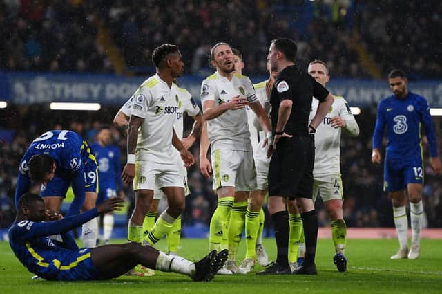 PROTESTS: Leeds United players complain to Chris Kavanagh as he awards Chelsea a penalty