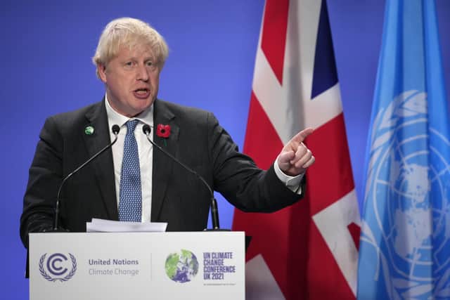 Britain's Prime Minister Boris Johnson speaks during a press conference as the world leaders summit at COP26 comes to a close at SECC on November 2, 2021 in Glasgow, Scotland.