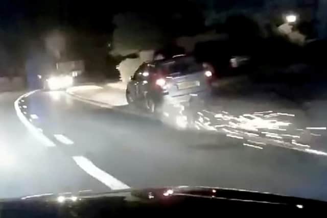 Sparks fly from the car during the chase