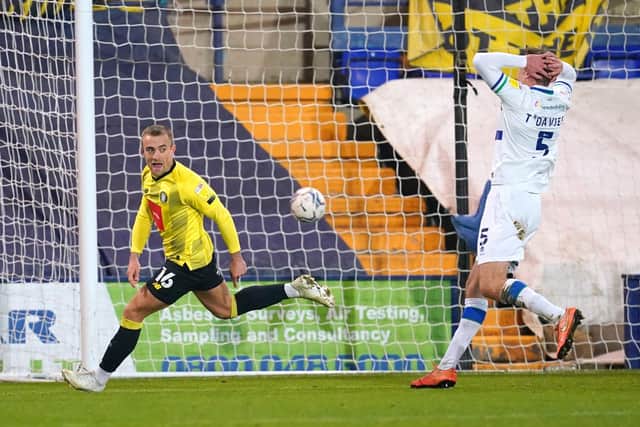Harrogate Town's Alex Pattison (left) celebrates scoring their winning goal at Tranmere. Pictures: PA