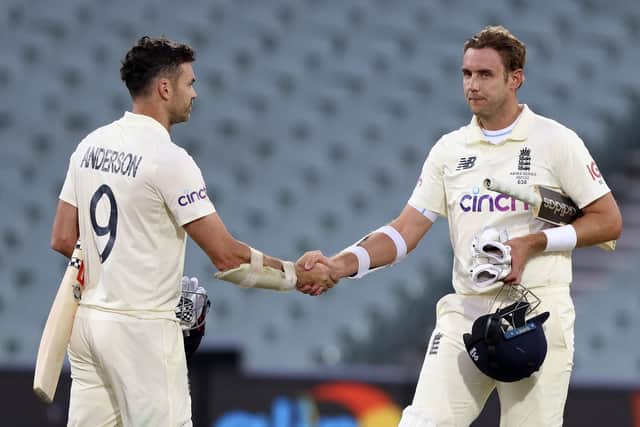 England's James Anderson, left, and Stuart Broad shake hands after losing the second ashes Test against Australia in Adelaide. Picture: AP/James Elsby