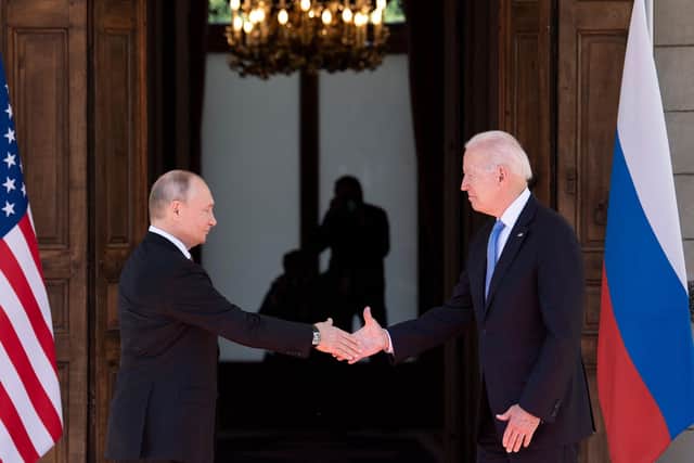 Russian President Vladimir Putin (L) shakes hands with US President Joe Biden prior to the US-Russia summit at the Villa La Grange, in Geneva on June 16, 2021.