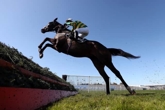 Chantry House ridden by jockey Nico de Boinville clear a fence on their way to winning the Betway Mildmay Novices' Chase during Ladies Day of the 2021 Randox Health Grand National Festival at Aintree.