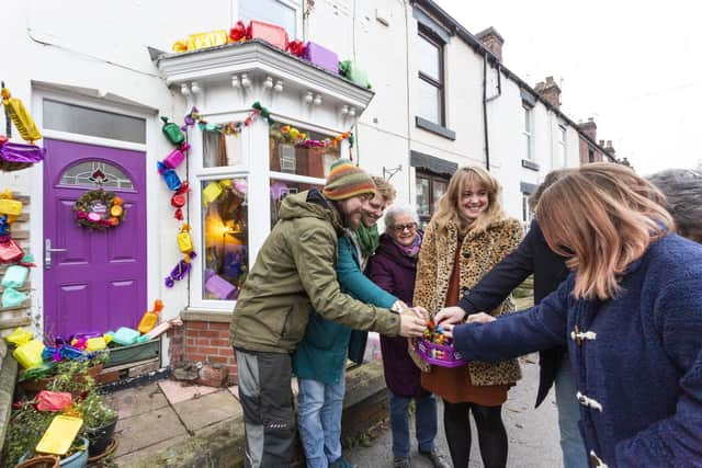 L-R Richard Smith, Rebecca Notte, Sue Benson, Kayleigh Thomas, and other residents tuck into a tub of Quality Streets.