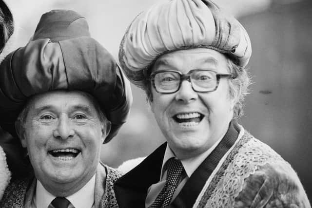 Eric Morecambe and Ernie Wise pose in Christmas costumes in 1983.