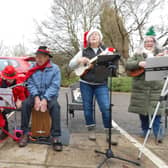 Ukulele players perform carols in the grounds at Wold Haven Care Home.