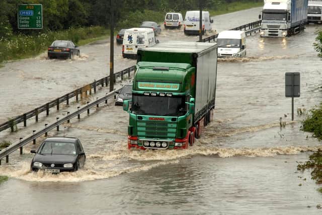 Motorists driving through deep flood water on the A63 road into Hull during the 2007 floods