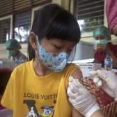 A girl receives a shot of the Sinovac COVID-19 vaccine during a vaccination campaign at an elementary school in Bali, Indonesia on Thursday, December  23, 2021.