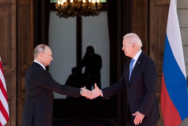 Russian President Vladimir Putin (L) shakes hands with US President Joe Biden prior to the US-Russia summit at the Villa La Grange, in Geneva on June 16, 2021, but will the next year see conflict in Ukraine?