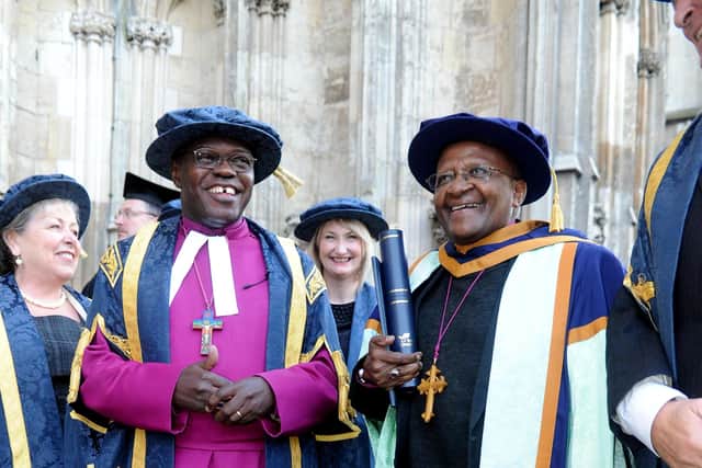 Archbishop of York, Dr John Sentamu stands next to Archbishop Desmond Tutu, outside of York Minster after receiving an Honorary Doctor of Laws from York St John University.