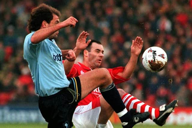 Game to remember: Manchester City's Uwe Rosler in action with Barnsley's Darren Sheridan.