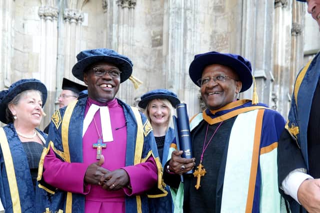 The then Archbishop of York, Dr John Sentamu, stands next to Archbishop Desmond Tutu, outside of York Minster after receiving an Honorary Doctor of Laws from York St John University in 2012. Photo: James Hardisty.